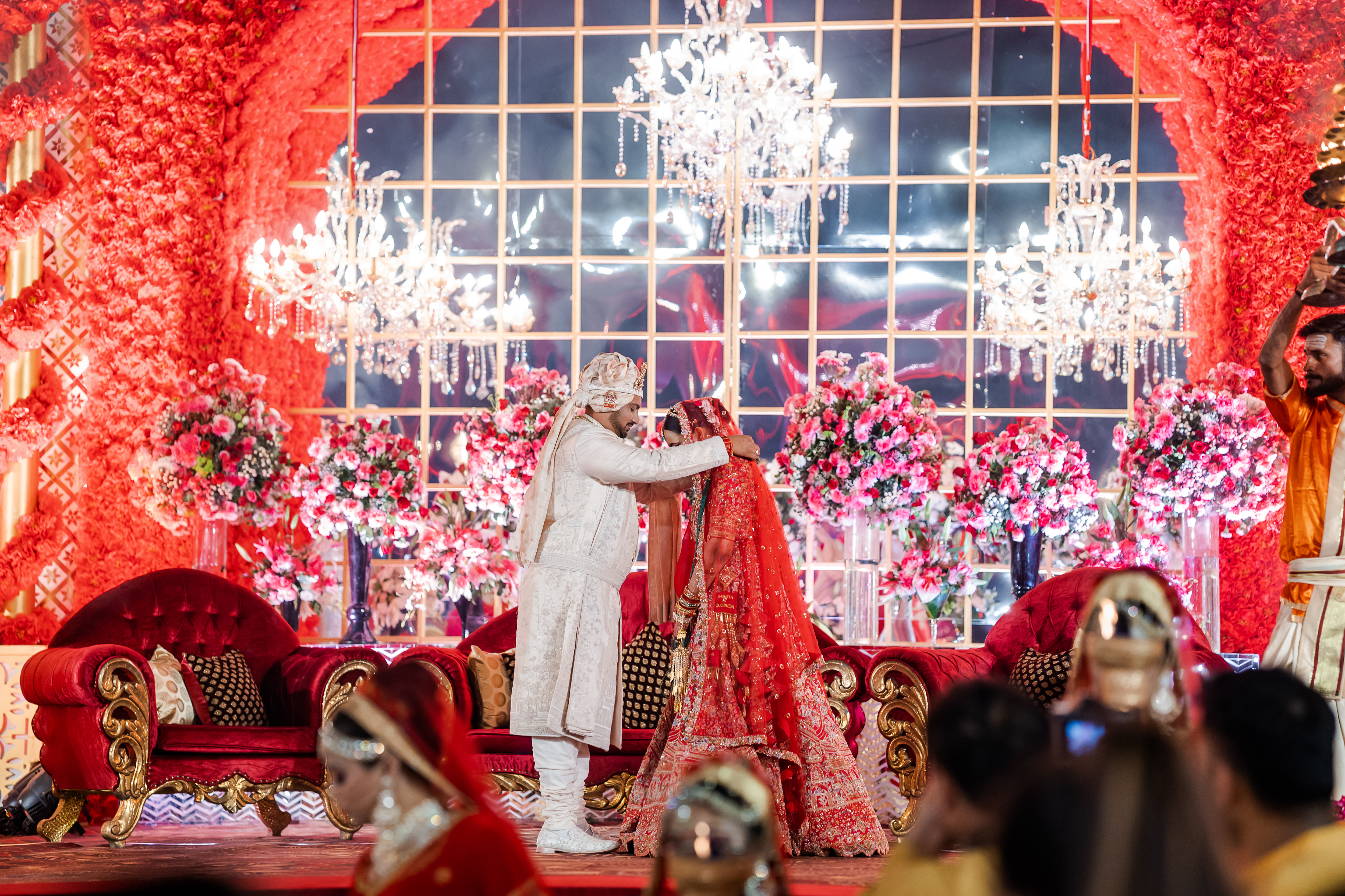 Bride and groom at the varmala on a floral stage