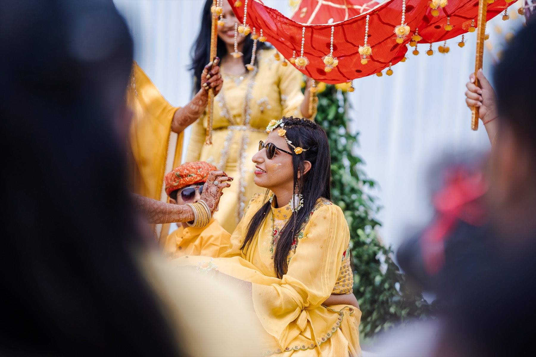Bride and a young cousin in turbans and sunglasses at the haldi