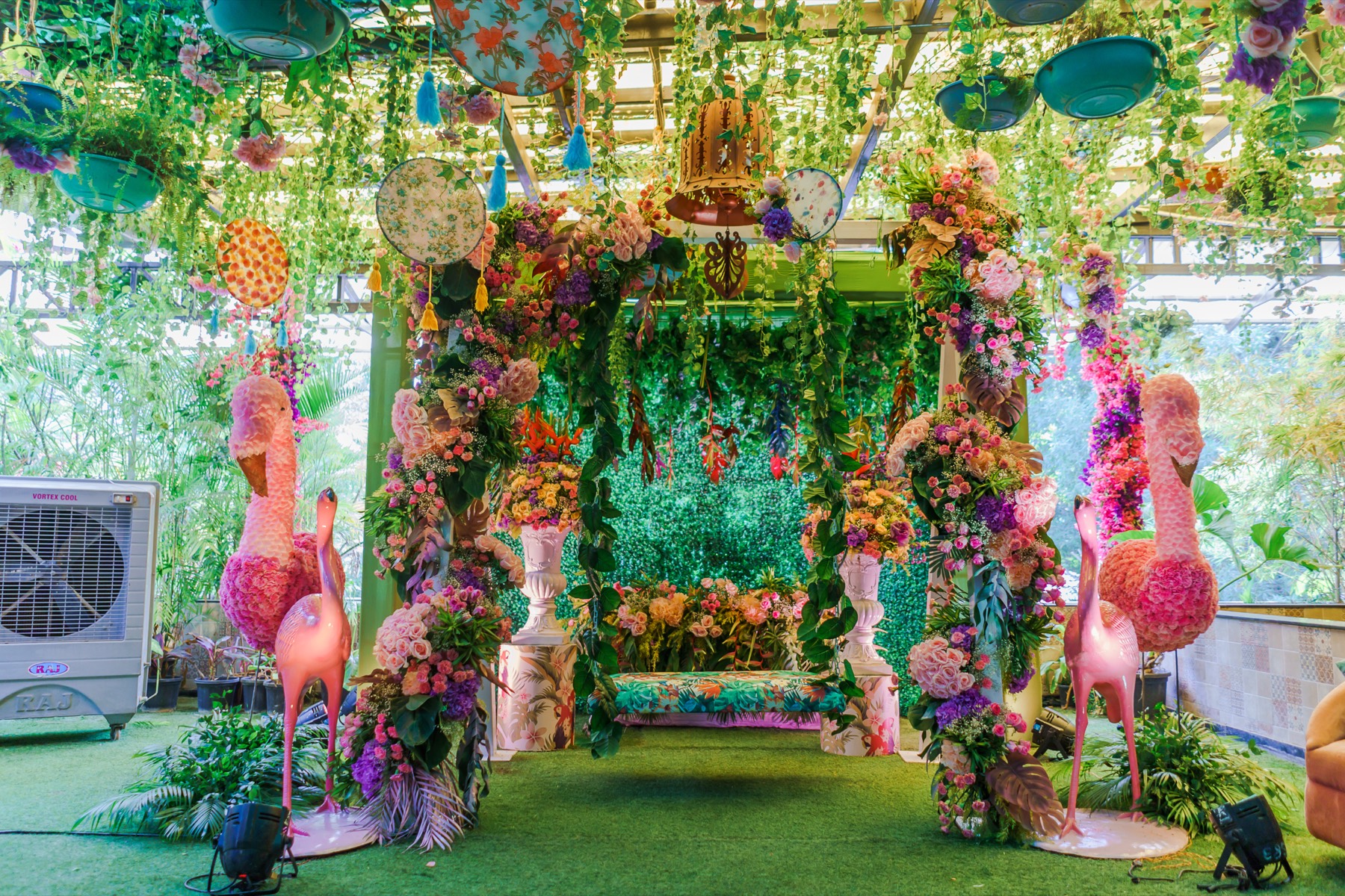 Whimsical floral mehndi decor with a swing and flamingo accents