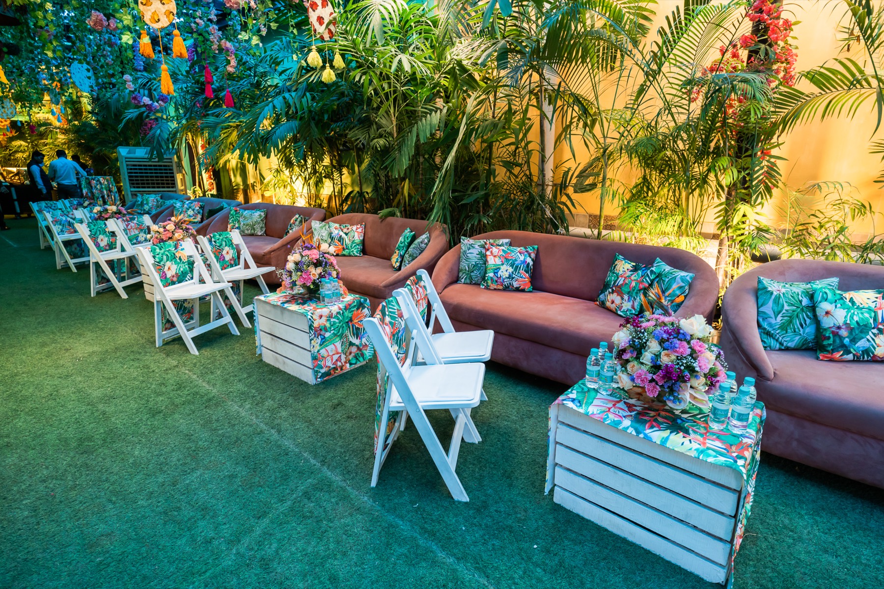 Lounge seating with floral printed cushions in a tropical setting