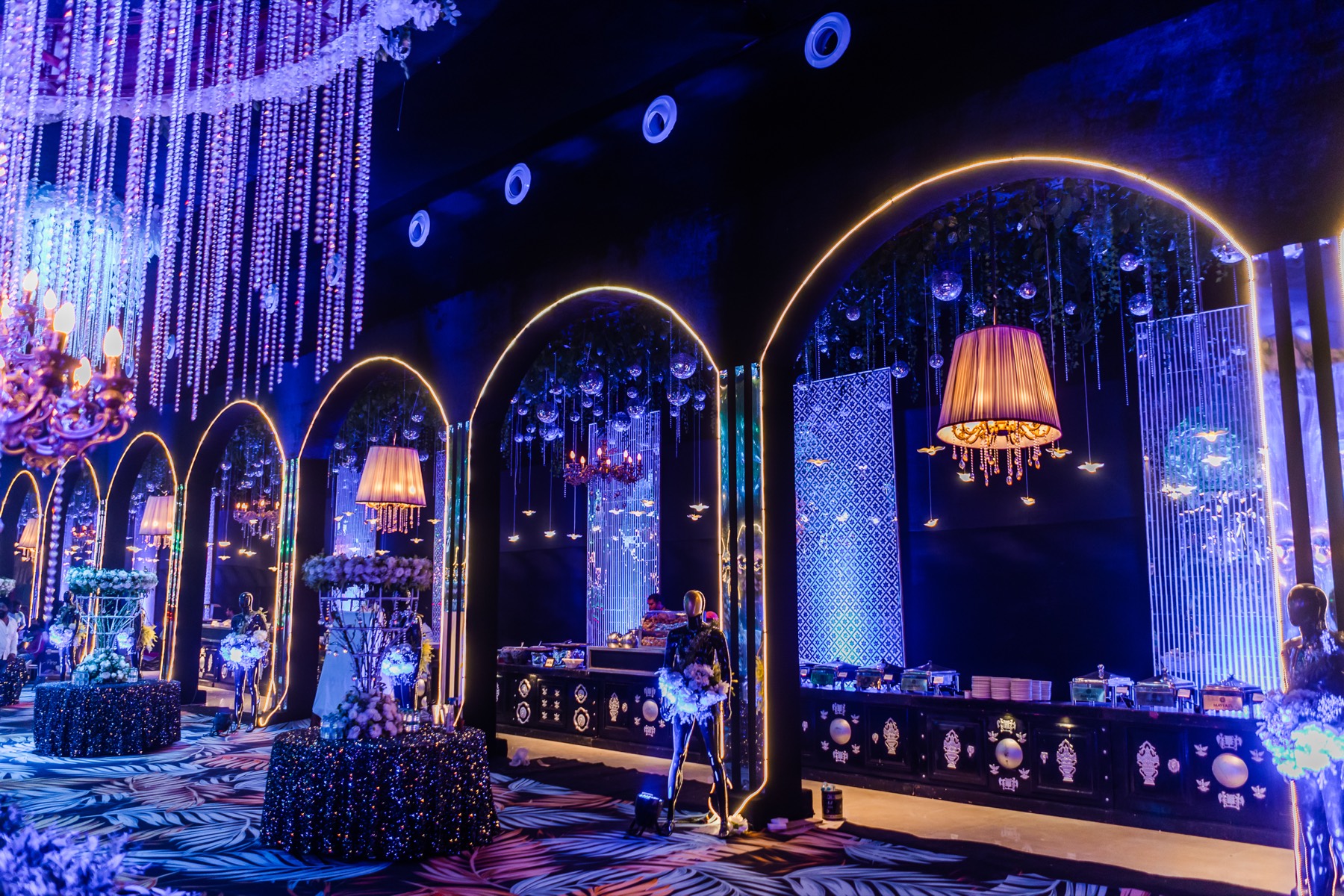 A reception hall of golden arches and chandeliers